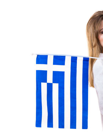 Unrecognizable woman holding Greece greek national flag being patriotic loving her country.の写真素材