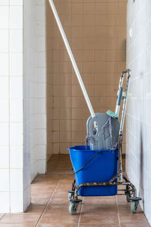 Trolley with bucket full of water and mop. Household or industrial cleaning objects.の写真素材