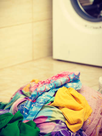 Big pile of colorful dirty clothes for laundry. Messy fabric, household duties objects concept.の写真素材