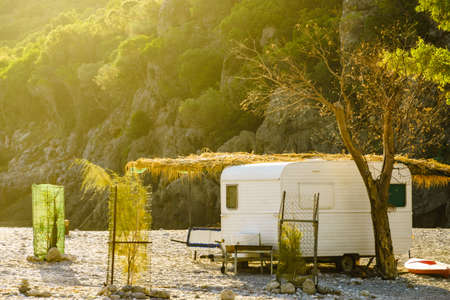 Tourism vacation and travel. Caravan trailer on sunny beach in Greeceの写真素材