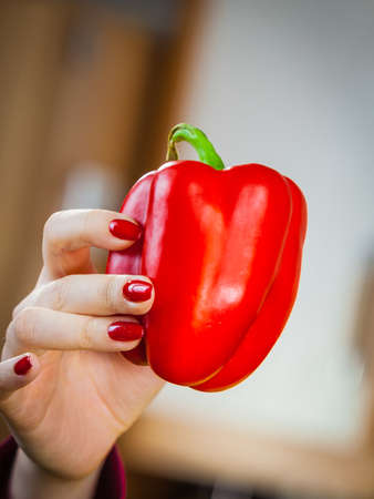 Woman holding red bell pepper. Healthy lifestyle, eating vegetables, vegetarian food concept.の写真素材