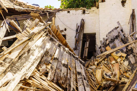 Abandoned wooden building, a ruin built of wood planks, destroyed, collapsed property.の写真素材
