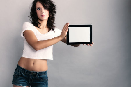 Technology. Sexy girl young attractive woman in summer clothes showing copy space on tablet...