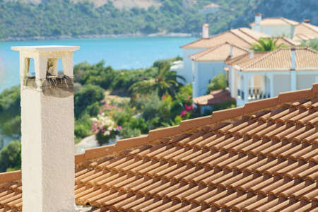 Roofs of Greek houses in suburbs of seaside tourist town. Mediterranean architecture, traveling in Europe for vacations.の写真素材