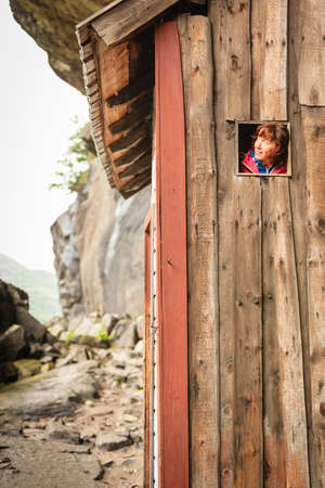 Tourist woman visiting the Helleren houses in Jossingfjord along road 44 between Egersund and Flekkefjord, Sokndal municipality, Norway.の写真素材