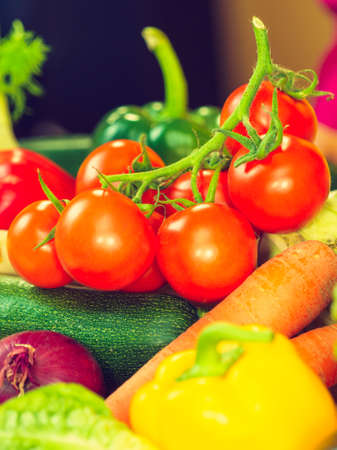 Many healthy colorful vegetables on kitchen table. Dieting, vegetarian local fresh food, natural source of vitamins.の写真素材