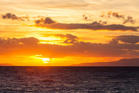 Scenic sunrise or sunset over sea surface, Greeceの写真素材