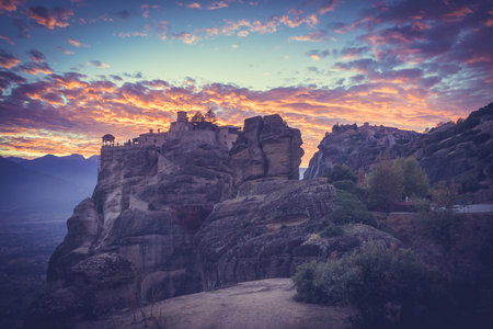 Scenic sunset evening sky over holy Varlaam monastery on cliff in Meteora, Thessaly Greece. Greek...