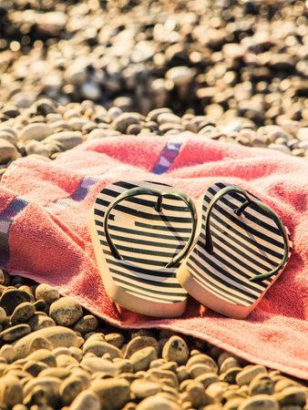 Beach accessories on a towel for sunbathing.