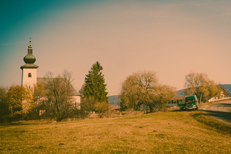 Church on hill, autumnal scenery in Slovakiaの写真素材