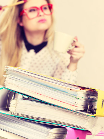 Happy woman at office drinking hot coffee or tea enjoying her break time during work. Job relax.