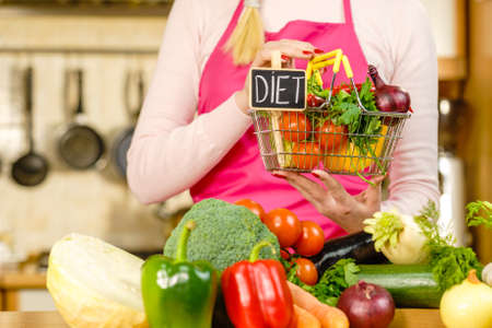 Shopping basket with diet sign and many colorful vegetables. Healthy eating lifestyle, vegetarian food.の写真素材