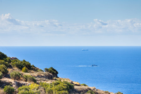 Seascape with ship on calm water surface.