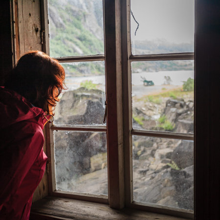 Tourist woman visiting the Helleren houses in Jossingfjord along road 44 between Egersund and Flekkefjord, Sokndal municipality, Norway.の写真素材
