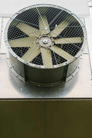 Close up of windmills ventilator in an industrial fan with a metal protective net.