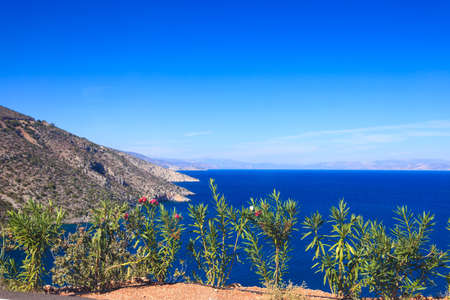 View from cliff on beautiful Greek seaside coastline. Sea water, blue ocean.の写真素材