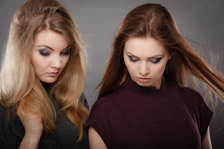 Beauty and fashion of woman. Attractive glamorous stunning girls. Portrait of gorgeous perfect styled trendy women photomodels posing together.の写真素材