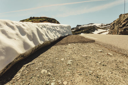 High snow wall and mountain road Aurlandsvegen between Aurland and Laerdal in Norway, summer time