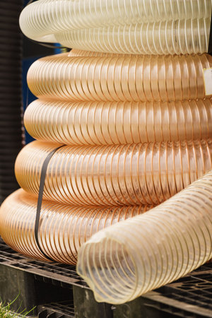 Close up of plastic made corrugated pipes. Agricultural rural machine details concept.