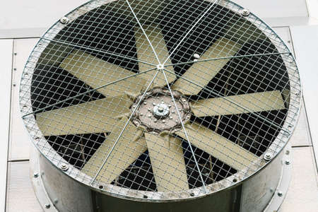 Close up of windmills ventilator in an industrial fan with a metal protective net.の写真素材