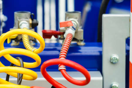 Close up of hydraulic hoses with valves and plugs. Industrial details vehicles concept.の写真素材