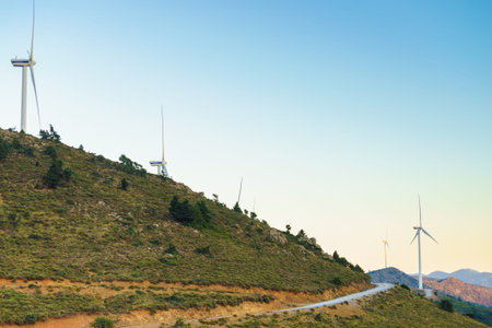Windmills on Greek hills. Wind farm, source of renewable green energy in Europe. Ecologogy concept.