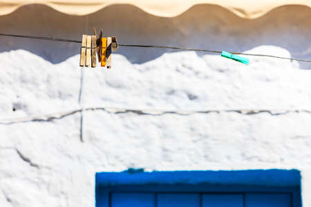 Wooden clothes pegs on a string outdoor. Household duties objects details concept.の写真素材