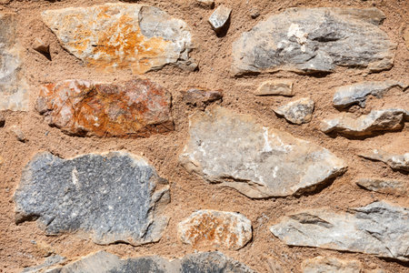 Wall made of stone bricks. Texture, background in the ancient style. Architectural details of...