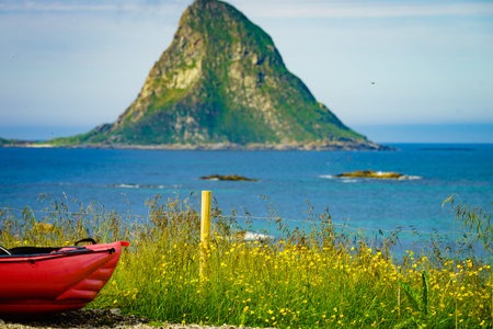 Seascape, sea coast with red canoe kayak on shore, resort Bleik Andoya Norway. Vesteralen...