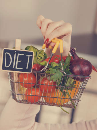 Shopping basket with diet sign and many colorful vegetables. Healthy eating lifestyle, vegetarian food.の写真素材