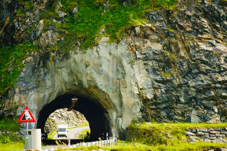 Road with old tunnel in green summer mountains, Norway. National tourist Andoya route.の写真素材