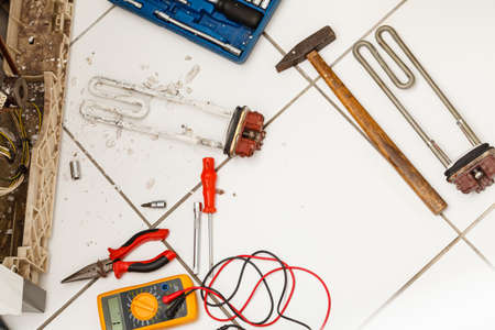 Machine industry repeair mechanical concept. Tools with washing machine. Broken laundromat with parts and tool set.の写真素材