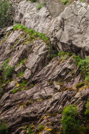Background of natural stone wall texture rough rock surfaceの写真素材
