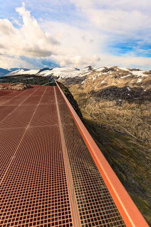 Scenic view on mountains landscape from Dalsnibba viewpoint, Geiranger Skywalk platform floor surface and glass guard rail, Norway.の写真素材