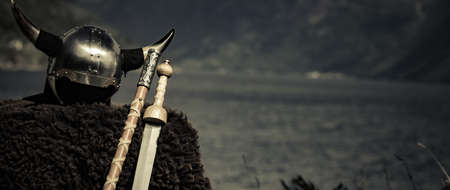 Viking helmet with weapons on fjord shore in Norway. Tourism and traveling conceptの写真素材
