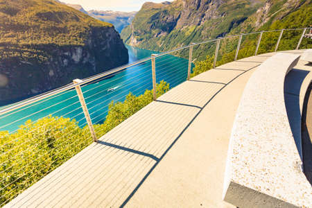 Ornesvingen view point with lookout seat. Geiranger fjord landscape. National Tourist Route in Norwayの写真素材