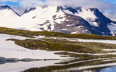Sport activity. Cross country summer ski at road 55 Sognefjellet national tourist route between Lom and Luster, Norway. People training on track. Sport activity. Cross country summer ski at road 55 Sognefjellet national tourist route between Lom and Luster, Norway. People training on track.