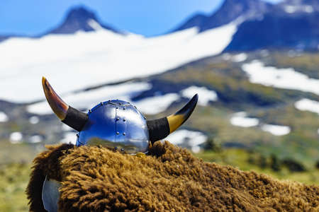 Viking helmet and brown fur on mountains nature in Norway. Tourism and traveling conceptの写真素材