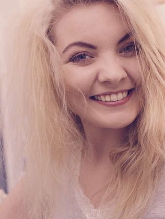 Happy woman having wet blonde hair. Positive clean female after taking a shower feeling clean and relaxed.の写真素材