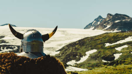 Viking warrior with helmet and fur in mountain nature, Norway. Tourism and traveling conceptの写真素材