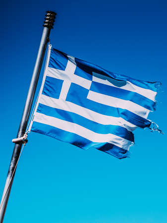 Close up of blue nad white Greek flag waving on wind. National landmark concept.の写真素材