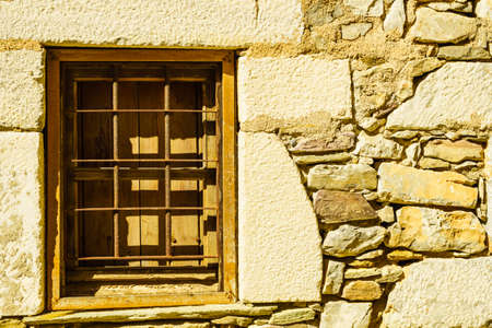 Window frame made of brown wood. Old construction, ancient architecture. Enterior details.の写真素材