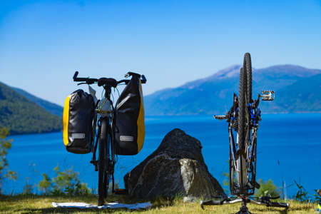 Bike repair. Mountain bicycle with saddlebag against nature, mountains fjord landscape in Norwayの写真素材
