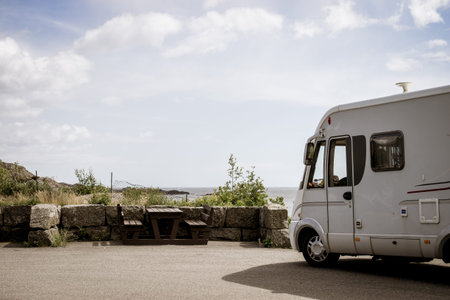 Tourism vacation and travel. Camper van and rocky coast landscape of southern Norway with an ocean...
