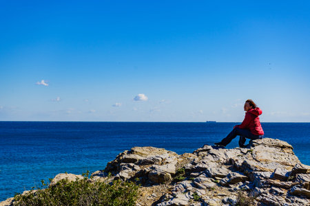 Tourist woman on Spanish rocky coastline in Murcia region. Mediterranean Sea coast landscape, Calblanque Regional Park.の写真素材