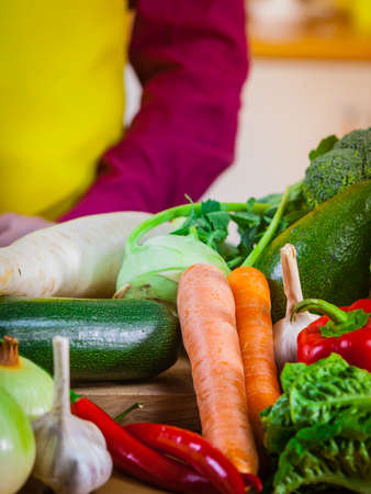 Close up of many healthy vegetables on kitchen table. Various colorful veggies, vegetarian meal ingredients.の写真素材