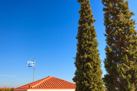 Blue and white Greek flag waving on wind in town. National landmark concept