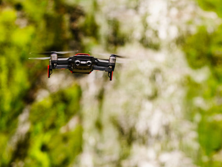 Drone flying against norwegian nature, mountain waterfall, take photo and video