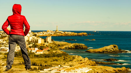 Tourist woman relaxing on spanish seashore. Mediterranean Sea coast landscape, coastline in Murcia...