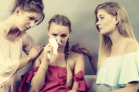 Female women comforting her woman sad friend helping her dealing with problems.の写真素材